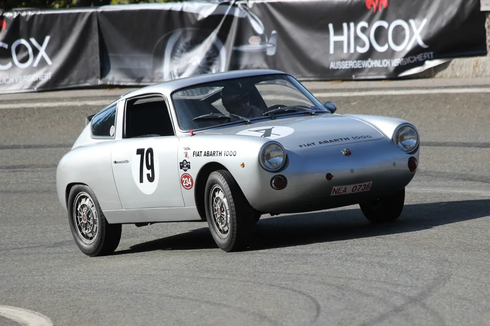 Silver Fiat-Abarth 1000 Bialbero racing at a hillclimb event, front three-quarter view, in motion