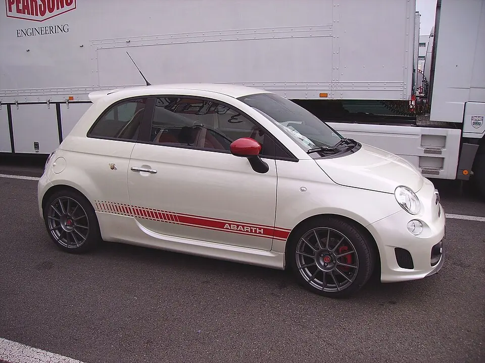 White Fiat 500 Abarth with red side stripe, side view
