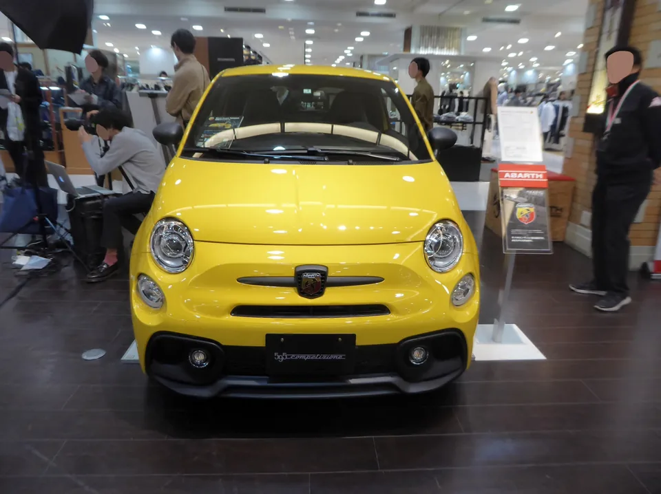 Yellow Abarth 595 Competizione, front view, indoor auto show