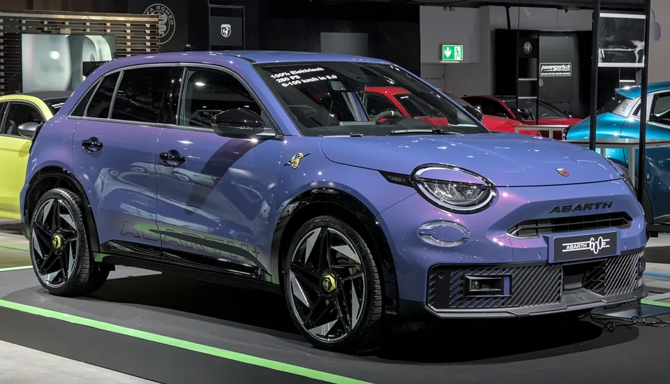 Purple Abarth 600e Scorpionissima, front three-quarter view, indoor auto show