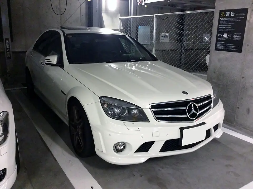 White Mercedes-AMG C63 (W204) sedan, three-quarter front view