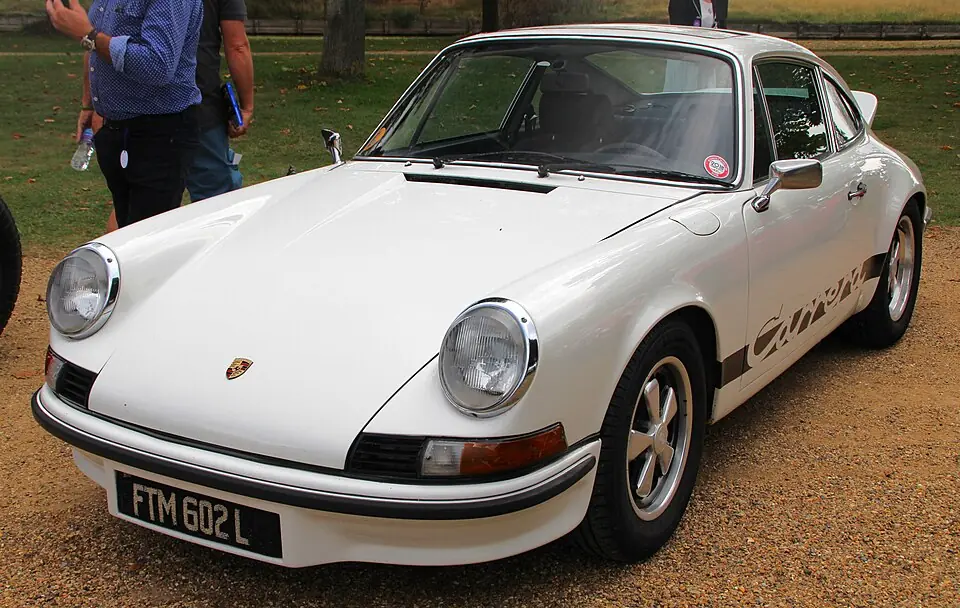 White Porsche 911 Carrera RS 2.7 with side Carrera script, front three-quarter view