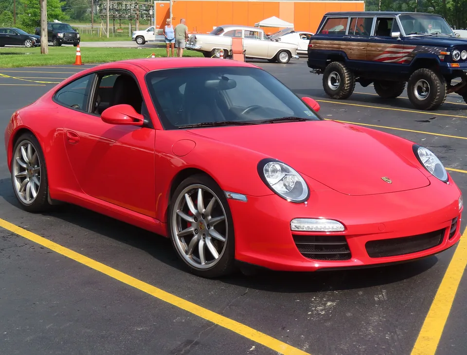 Guards Red Porsche 911 Carrera S (997.2) coupé at a Pennsylvania car show, three-quarter front view