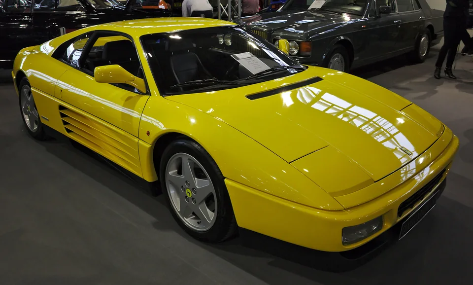 Yellow Ferrari 348 tb, three-quarter front view