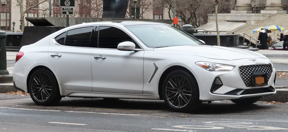 White Genesis G70 3.3T parked in Manhattan, three-quarter front view