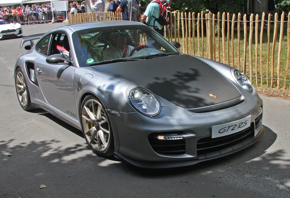 Silver Porsche 911 GT2 RS (997) with carbon bonnet at the Goodwood Festival of Speed, three-quarter front view