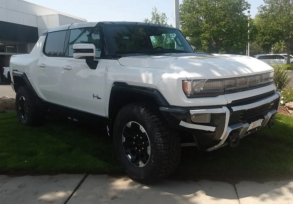 White GMC Hummer EV pickup, three-quarter front view
