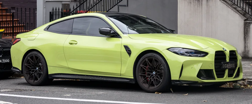Bright yellow-green BMW M4 Competition (G82), three-quarter front view