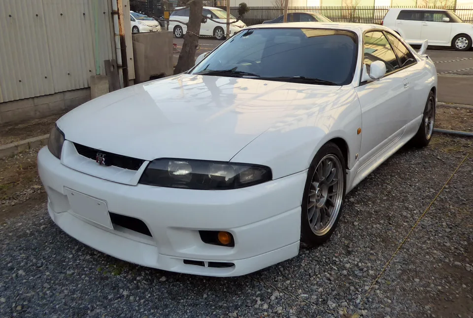 White Nissan Skyline GT-R (R33), three-quarter front view