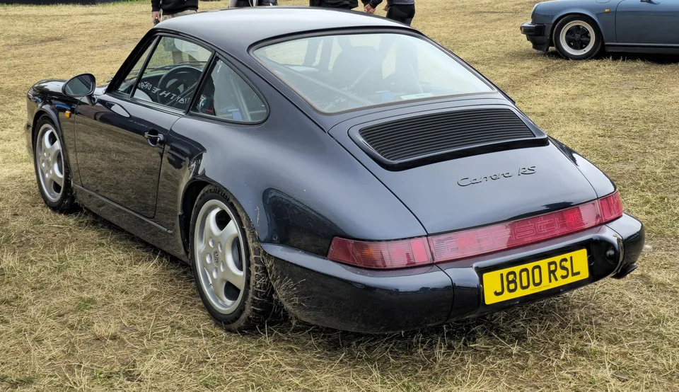 Dark blue Porsche 911 Carrera RS (964), three-quarter rear view