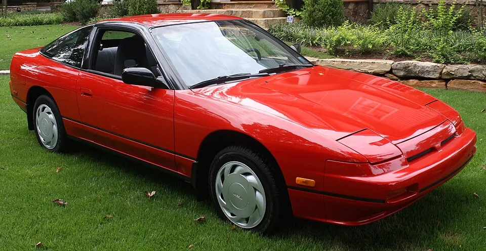 Black Nissan 240SX S13 fastback, three-quarter front view