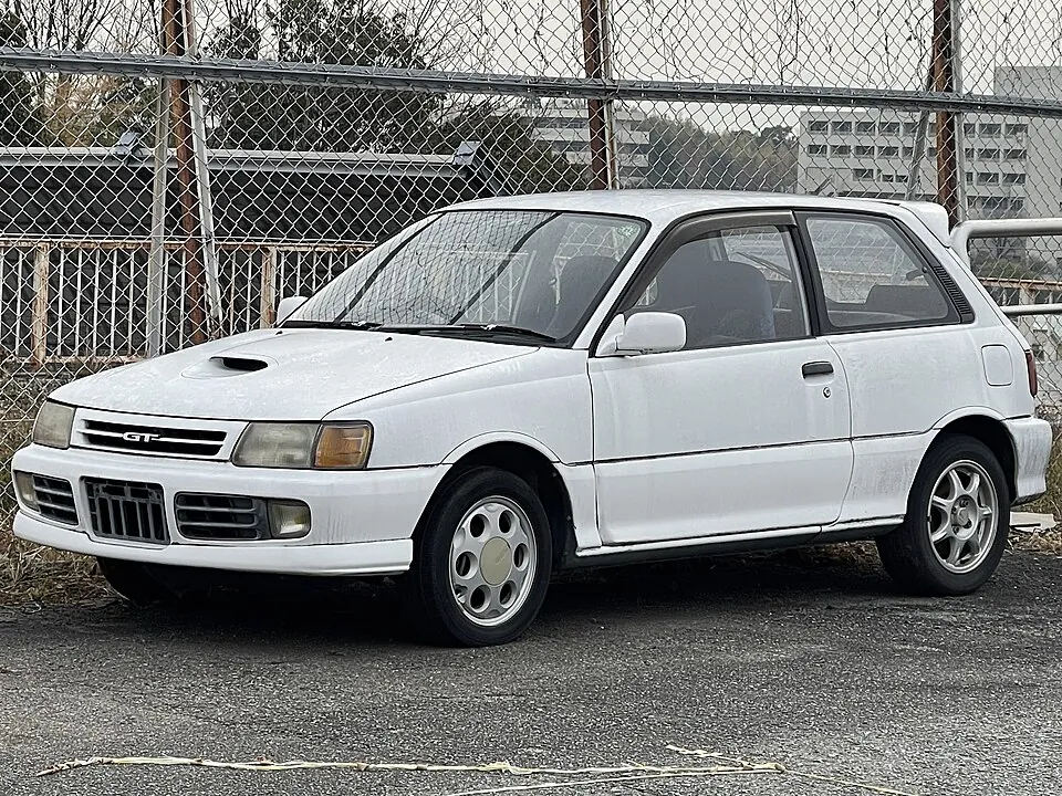 White Toyota Starlet GT (EP82) with bonnet scoop, front three-quarter view