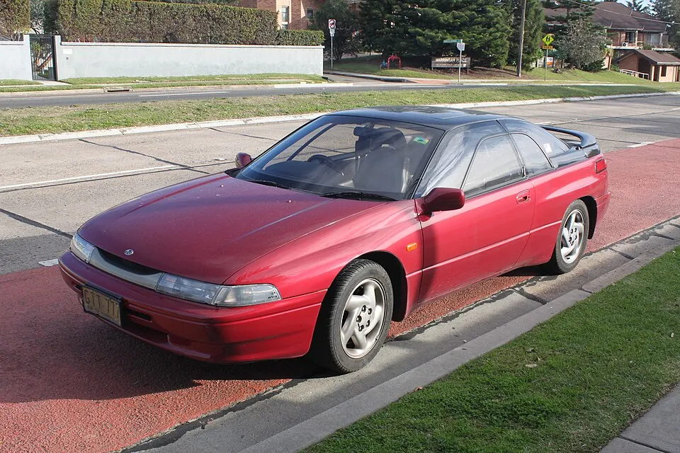 Red Subaru SVX with window-within-a-window glass, front three-quarter view