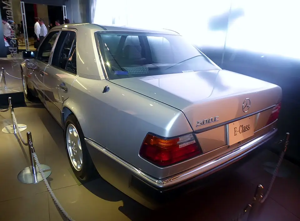 Silver Mercedes-Benz 500E W124, rear three-quarter view