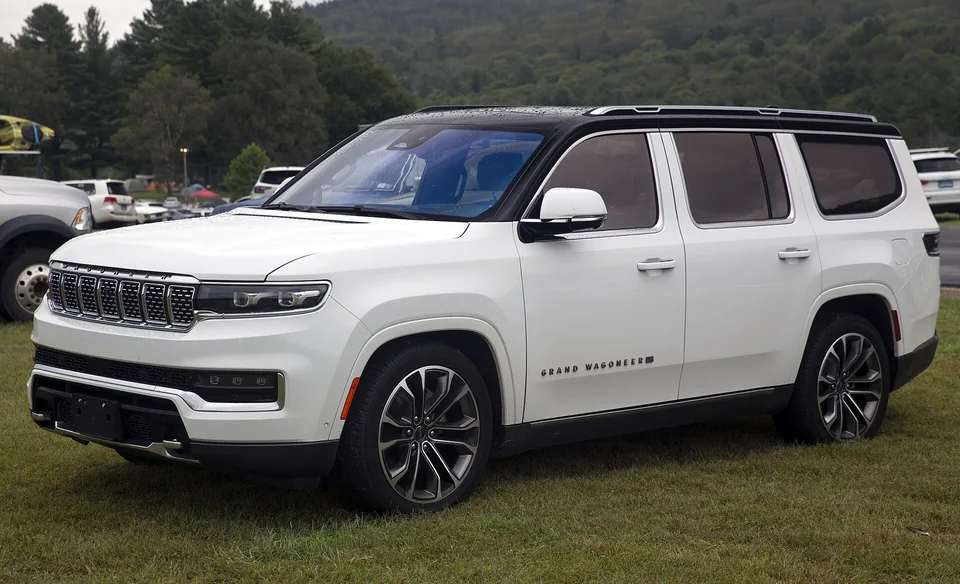 White and black 2022 Jeep Grand Wagoneer Series III at Lime Rock, three-quarter front view